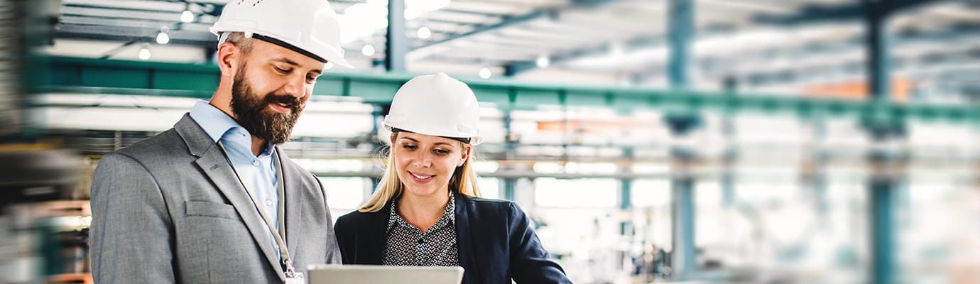 two executives in a manufacturing facility
