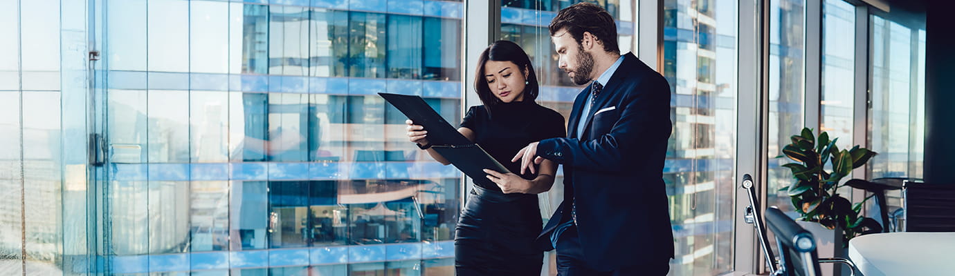 Two persons discussing in building