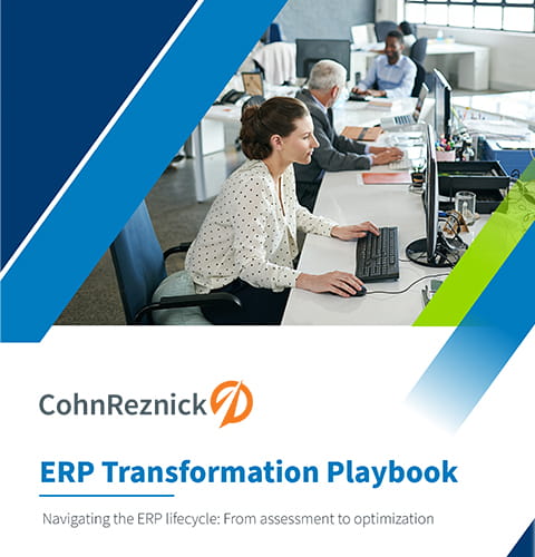 colleagues working together at a desk in an office