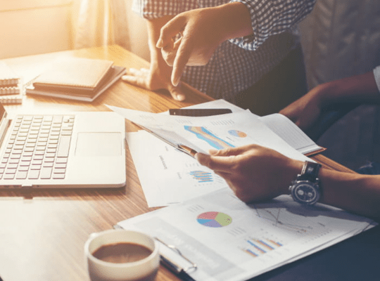 a team looking at analytics paperwork