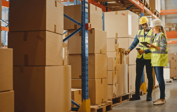 factory workers looking at a clipboard