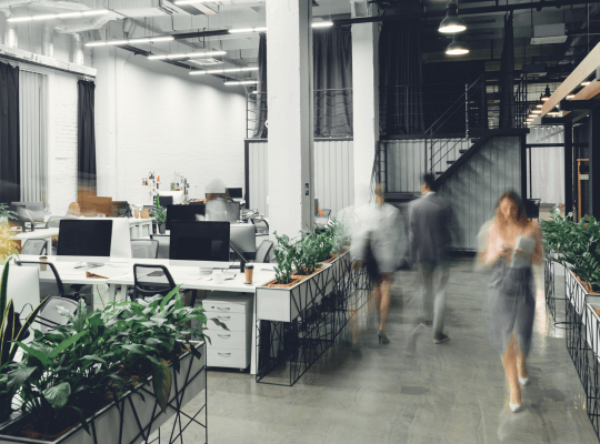 people walking through an office